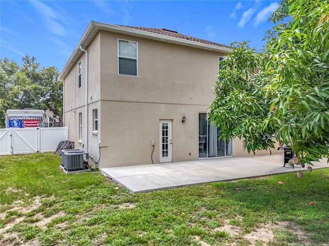 238 Hunt St, Clermont, FL 34711 - back of property with a gate, stucco siding, and a patio area