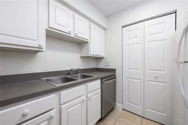 3700 Idlebrook Cir Unit 200, Casselberry, FL 32707 - kitchen with dishwasher, white cabinets, dark countertops, and freestanding refrigerator
