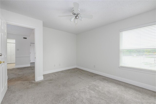 3700 Idlebrook Cir Unit 200, Casselberry, FL 32707 - spare room featuring light carpet, ceiling fan, and a textured ceiling