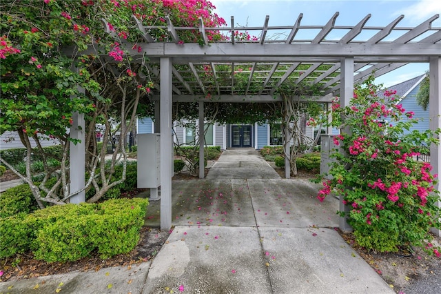 3700 Idlebrook Cir Unit 200, Casselberry, FL 32707 - view of patio / terrace featuring french doors, a pergola, concrete driveway, and a carport