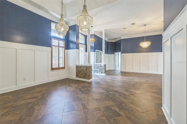 1818 W Cobblestone Ln, Saint Augustine, FL 32092 - unfurnished dining area featuring a decorative wall, a chandelier, a wainscoted wall, and crown molding