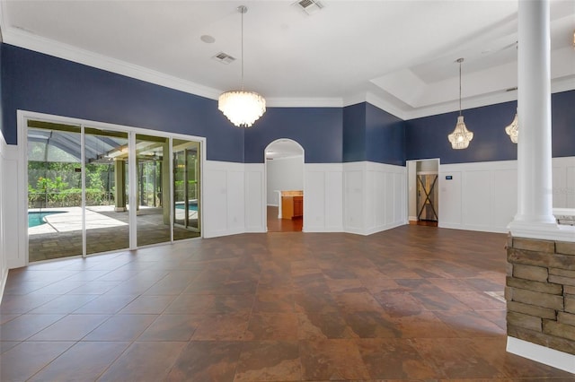 1818 W Cobblestone Ln, Saint Augustine, FL 32092 - unfurnished room featuring a wainscoted wall, decorative columns, a decorative wall, ornamental molding, and arched walkways