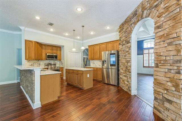 1818 W Cobblestone Ln, Saint Augustine, FL 32092 - kitchen featuring appliances with stainless steel finishes, arched walkways, dark wood-type flooring, backsplash, and a textured ceiling