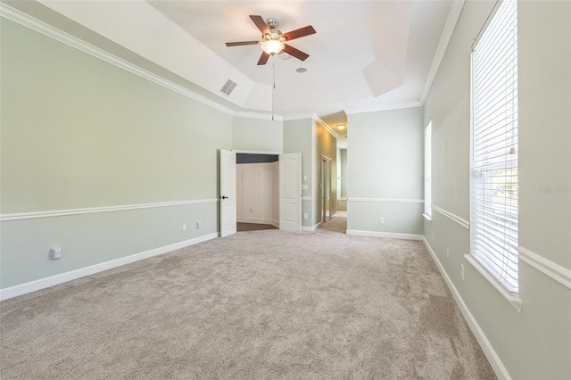 1818 W Cobblestone Ln, Saint Augustine, FL 32092 - unfurnished bedroom featuring carpet flooring, ornamental molding, connected bathroom, a tray ceiling, and a ceiling fan