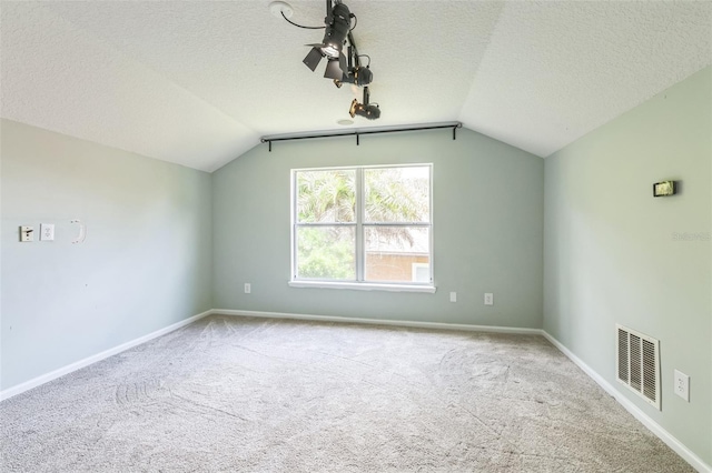1818 W Cobblestone Ln, Saint Augustine, FL 32092 - additional living space featuring lofted ceiling, carpet flooring, and a textured ceiling