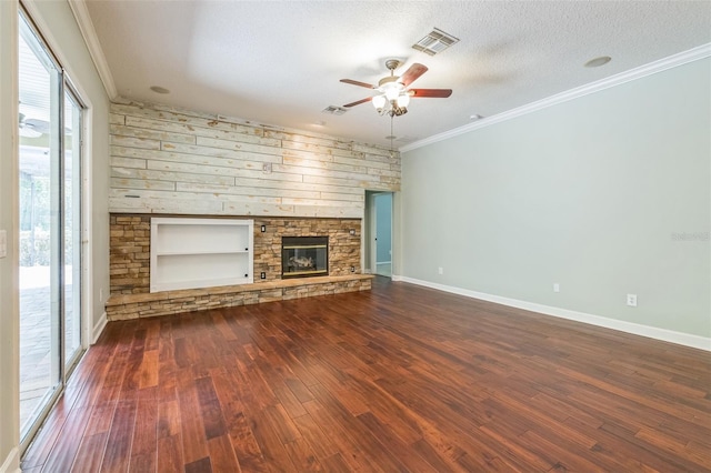 1818 W Cobblestone Ln, Saint Augustine, FL 32092 - unfurnished living room featuring wood finished floors, ceiling fan, a stone fireplace, ornamental molding, and a textured ceiling