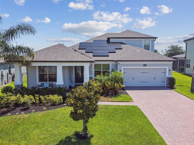 2433 Santa Vista Loop, Apopka, FL 32703 - view of front of home with decorative driveway, an attached garage, a front yard, roof mounted solar panels, and roof with shingles