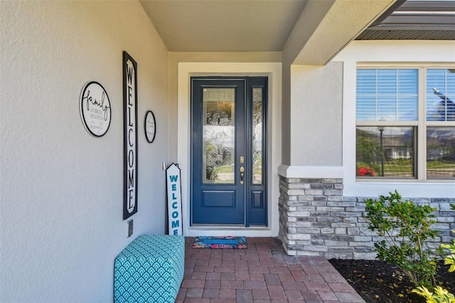2433 Santa Vista Loop, Apopka, FL 32703 - view of exterior entry featuring stucco siding and stone siding