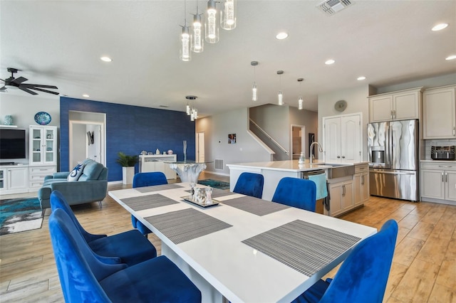 2433 Santa Vista Loop, Apopka, FL 32703 - dining area featuring recessed lighting, light wood-style floors, ceiling fan, stairs, and a chandelier