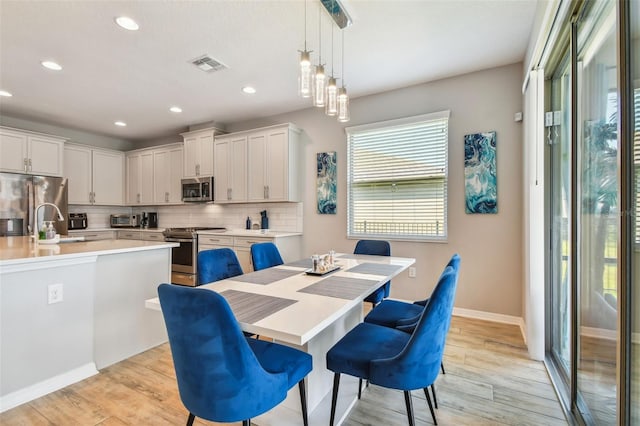 2433 Santa Vista Loop, Apopka, FL 32703 - dining space with light wood-style floors and recessed lighting