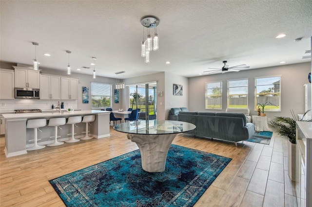 2433 Santa Vista Loop, Apopka, FL 32703 - dining room with light wood-type flooring, recessed lighting, a ceiling fan, and a chandelier