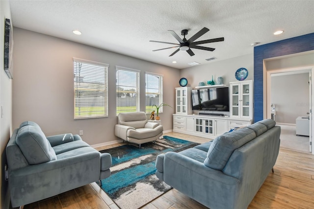 2433 Santa Vista Loop, Apopka, FL 32703 - living room with ceiling fan, a textured ceiling, light wood-style floors, and recessed lighting