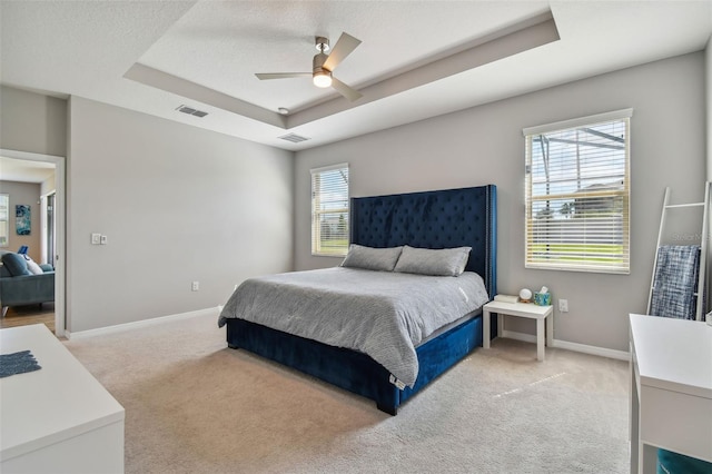 2433 Santa Vista Loop, Apopka, FL 32703 - bedroom featuring a tray ceiling, light carpet, and ceiling fan