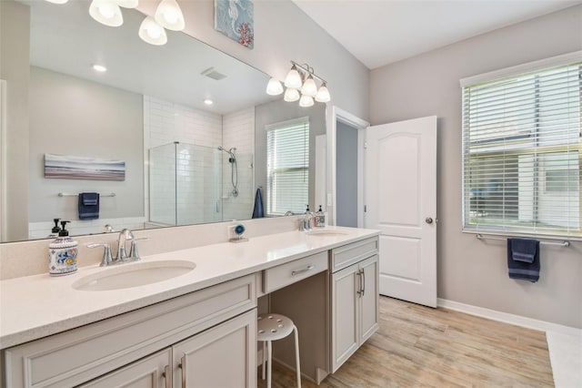 2433 Santa Vista Loop, Apopka, FL 32703 - bathroom featuring a shower stall, double vanity, and wood finished floors