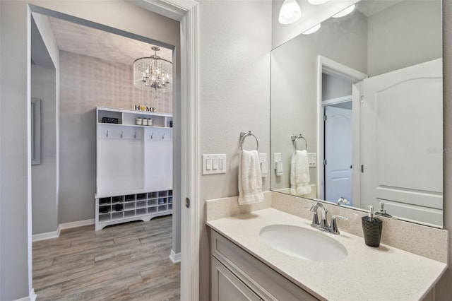 2433 Santa Vista Loop, Apopka, FL 32703 - bathroom with wood finished floors, vanity, and a chandelier