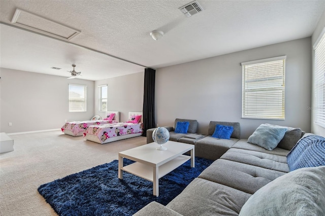 2433 Santa Vista Loop, Apopka, FL 32703 - carpeted living area featuring a textured ceiling and baseboards