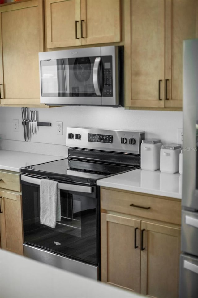 3324 Pink Oleander Ave, Mascotte, FL 34753 - kitchen featuring appliances with stainless steel finishes and light countertops