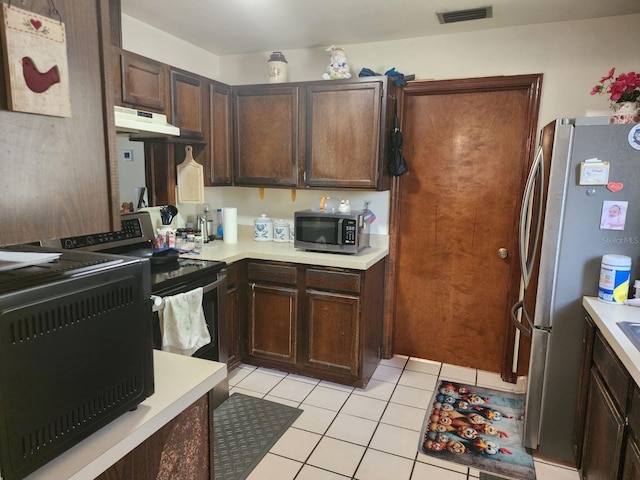 201 N Hart Rd, Geneva, FL 32732 - kitchen featuring appliances with stainless steel finishes, under cabinet range hood, light countertops, and light tile patterned floors
