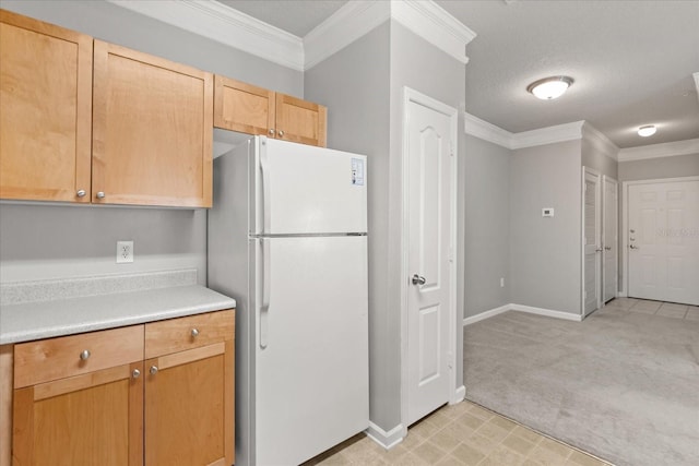8842 Villa View Cir Unit 207, Orlando, FL 32821 - kitchen with freestanding refrigerator, crown molding, light countertops, light carpet, and light brown cabinetry