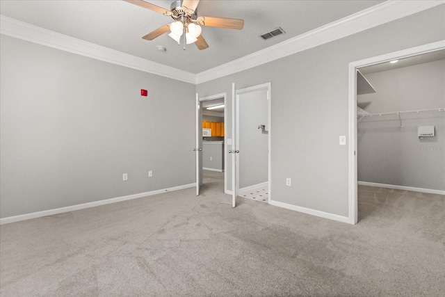 8842 Villa View Cir Unit 207, Orlando, FL 32821 - unfurnished bedroom featuring crown molding, carpet, a spacious closet, and a ceiling fan