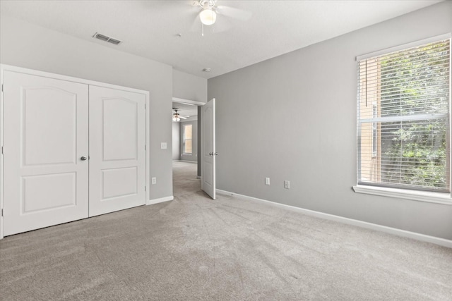 8842 Villa View Cir Unit 207, Orlando, FL 32821 - unfurnished bedroom with carpet flooring, a closet, and ceiling fan