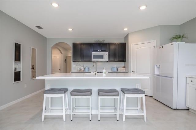 138 Old Mill Pond Rd, Edgewater, FL 32141 - kitchen featuring white appliances, light countertops, arched walkways, and recessed lighting