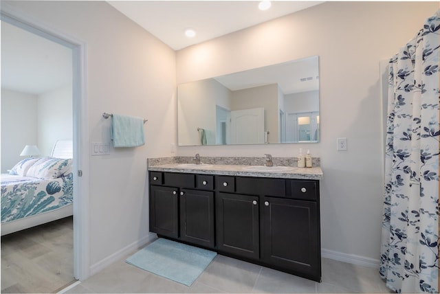 138 Old Mill Pond Rd, Edgewater, FL 32141 - ensuite bathroom featuring double vanity and baseboards