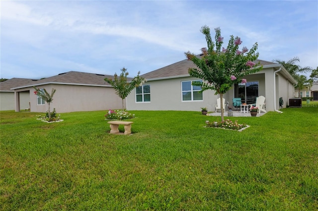 138 Old Mill Pond Rd, Edgewater, FL 32141 - rear view of property featuring a yard, a patio, and stucco siding