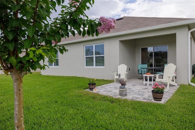 138 Old Mill Pond Rd, Edgewater, FL 32141 - back of property featuring stucco siding, a patio, a yard, and roof with shingles