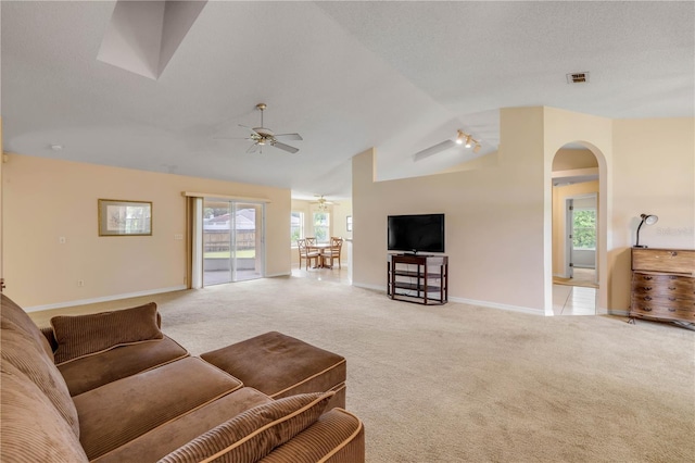 19 Potters Ln, Palm Coast, FL 32164 - living room featuring vaulted ceiling, a ceiling fan, light carpet, and arched walkways