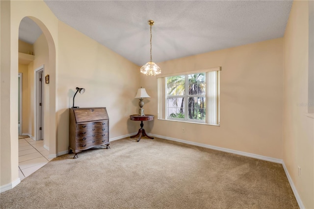 19 Potters Ln, Palm Coast, FL 32164 - empty room featuring carpet floors, arched walkways, a textured ceiling, and a chandelier