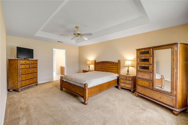 19 Potters Ln, Palm Coast, FL 32164 - bedroom featuring a raised ceiling, light colored carpet, ensuite bath, and a ceiling fan