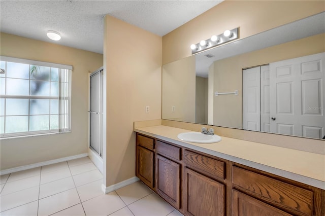 19 Potters Ln, Palm Coast, FL 32164 - full bath featuring vanity, a textured ceiling, a shower with shower door, and tile patterned flooring