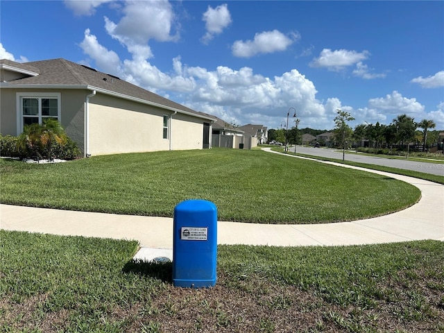 577 Talisi Loop, Saint Cloud, FL 34771 - view of side of property with stucco siding and a lawn