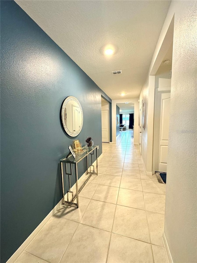 577 Talisi Loop, Saint Cloud, FL 34771 - corridor featuring a textured ceiling, light tile patterned floors, and a textured wall