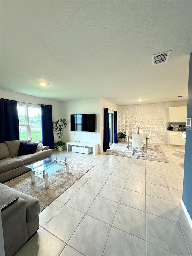 577 Talisi Loop, Saint Cloud, FL 34771 - living area featuring light tile patterned floors and a textured ceiling