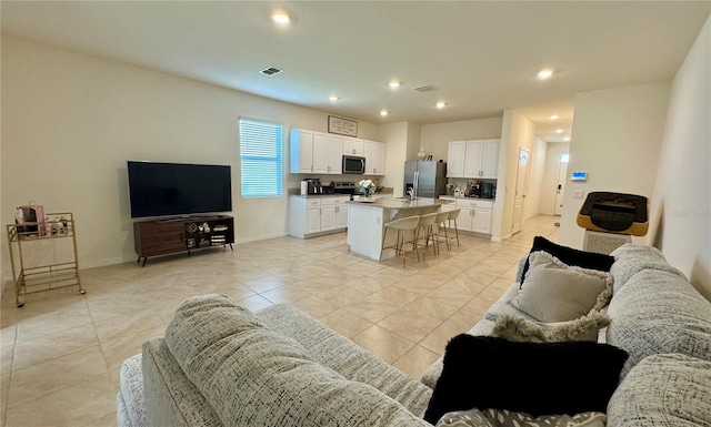 1314 Isleta Loop, Kissimmee, FL 34741 - living room with light tile patterned flooring, recessed lighting, and heating unit