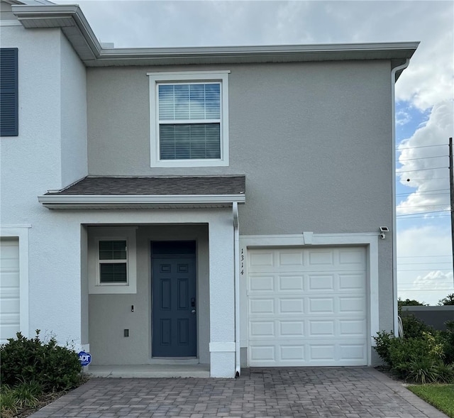 1314 Isleta Loop, Kissimmee, FL 34741 - townhome / multi-family property with stucco siding and a garage