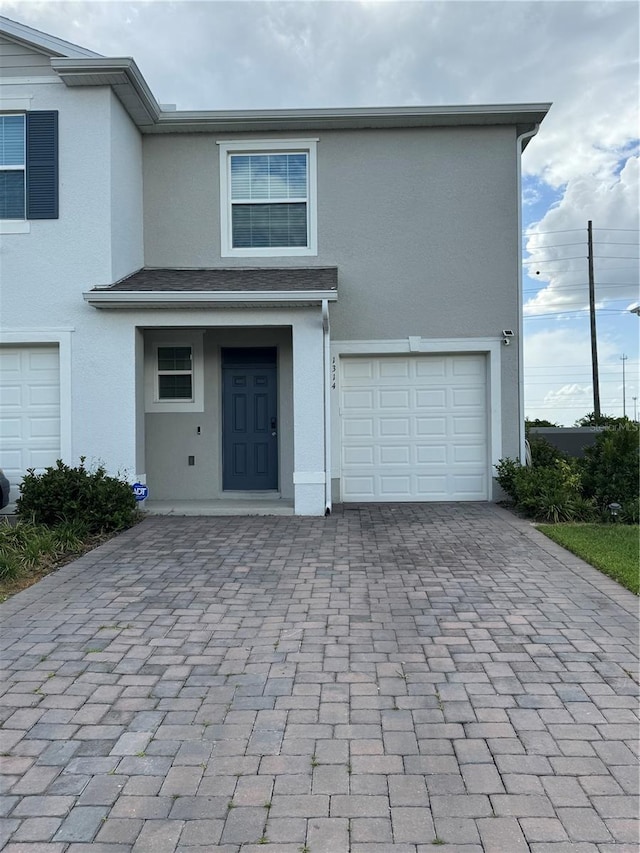 1314 Isleta Loop, Kissimmee, FL 34741 - multi unit property with decorative driveway, stucco siding, and a garage