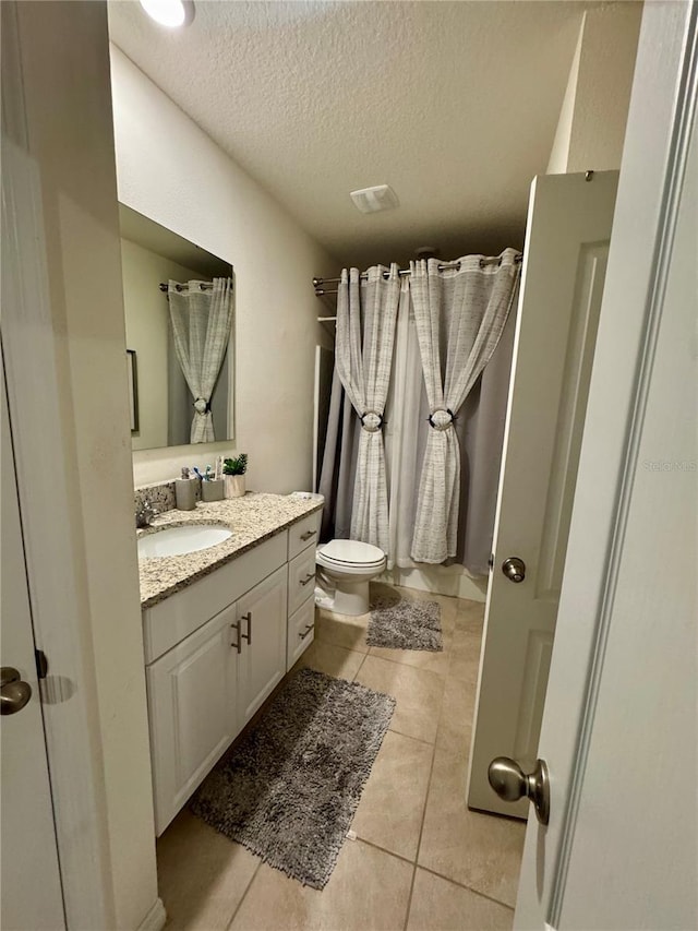 1314 Isleta Loop, Kissimmee, FL 34741 - bathroom featuring vanity, tile patterned flooring, and a textured ceiling