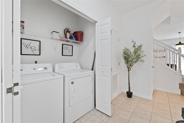 1176 S Beach Cir, Kissimmee, FL 34746 - washroom with separate washer and dryer and light tile patterned floors