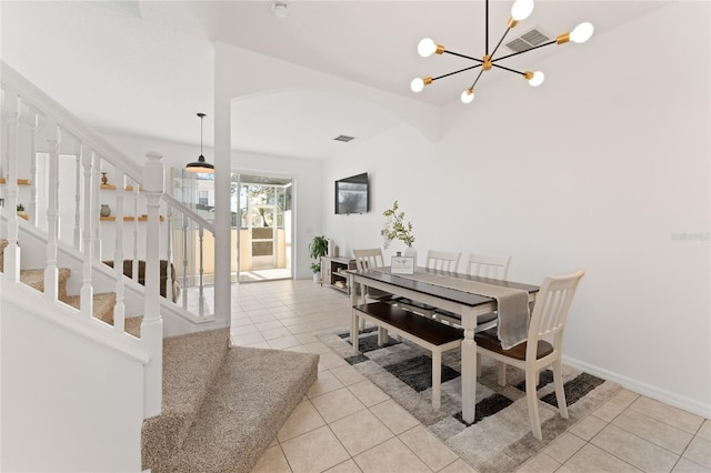 1176 S Beach Cir, Kissimmee, FL 34746 - dining space with arched walkways, tile patterned flooring, stairs, and a chandelier
