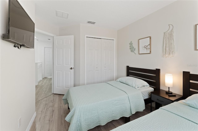 1176 S Beach Cir, Kissimmee, FL 34746 - bedroom with light wood finished floors and a closet