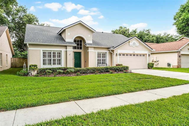 1326 Hampshire Place Cir, Altamonte Springs, FL 32714 - view of front facade with a garage, stucco siding, concrete driveway, a front lawn, and roof with shingles