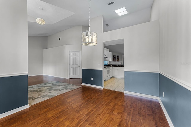 1326 Hampshire Place Cir, Altamonte Springs, FL 32714 - empty room with high vaulted ceiling, wood finished floors, and a chandelier