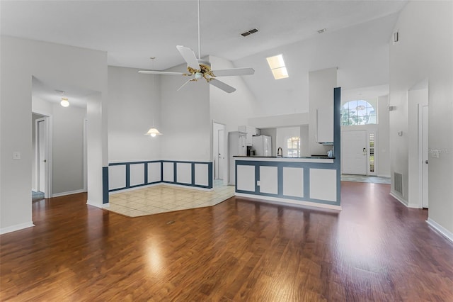 1326 Hampshire Place Cir, Altamonte Springs, FL 32714 - unfurnished living room with high vaulted ceiling, wood finished floors, and a ceiling fan