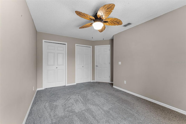 1326 Hampshire Place Cir, Altamonte Springs, FL 32714 - unfurnished bedroom featuring multiple closets, carpet, a textured ceiling, and ceiling fan