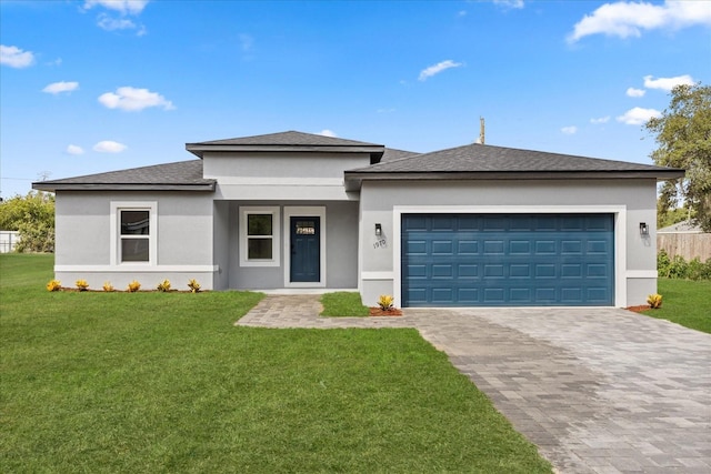 1970 SW 160th Pl, Ocala, FL 34473 - prairie-style house with stucco siding, decorative driveway, a front lawn, a garage, and roof with shingles