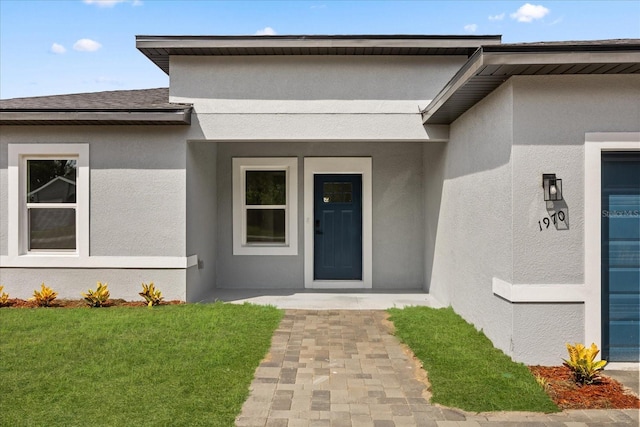 1970 SW 160th Pl, Ocala, FL 34473 - entrance to property with stucco siding and a lawn