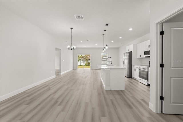 1970 SW 160th Pl, Ocala, FL 34473 - kitchen featuring appliances with stainless steel finishes, a chandelier, recessed lighting, white cabinetry, and light wood-style floors